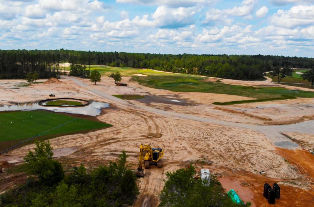 A Painter Land Development expert conducting land grading and excavation in Brevard, NC, explaining why they are the top choice for local site preparation. Land Grading & Excavation Near Me.